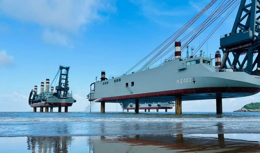 Chinese amphibious jackup barges on a beach.